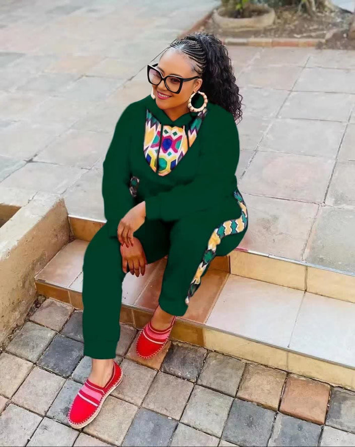 Green twin set with African print neckline and matching pants, long sleeves.