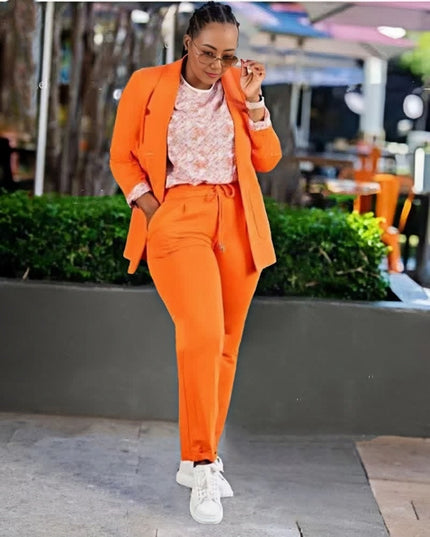 Orange blazer and matching trouser set with single-breast jacket and straight-leg pants.