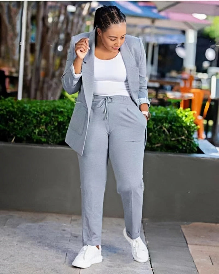 Grey blazer and matching trouser set with open-front blazer and tie-waist trousers.