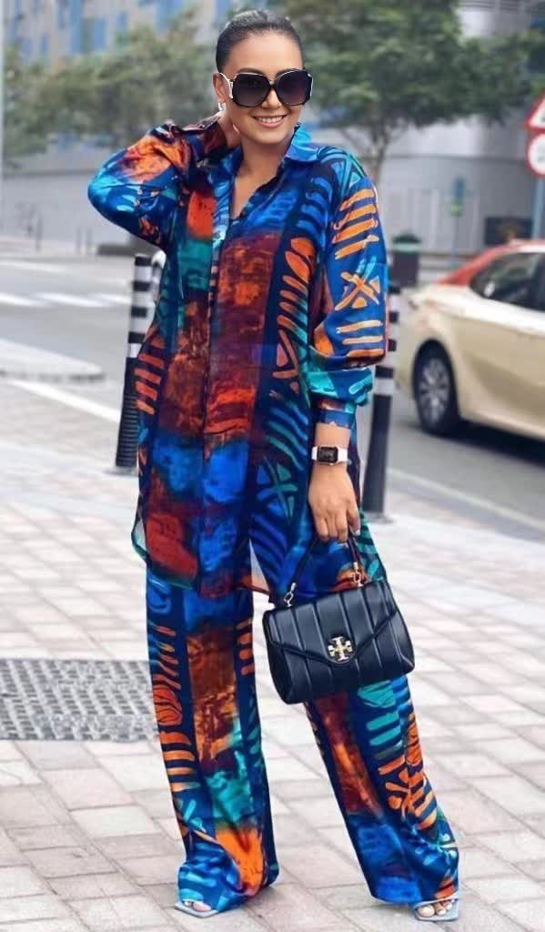Abstract printed twin set with long-sleeve button top and wide-leg pants, blue and orange.