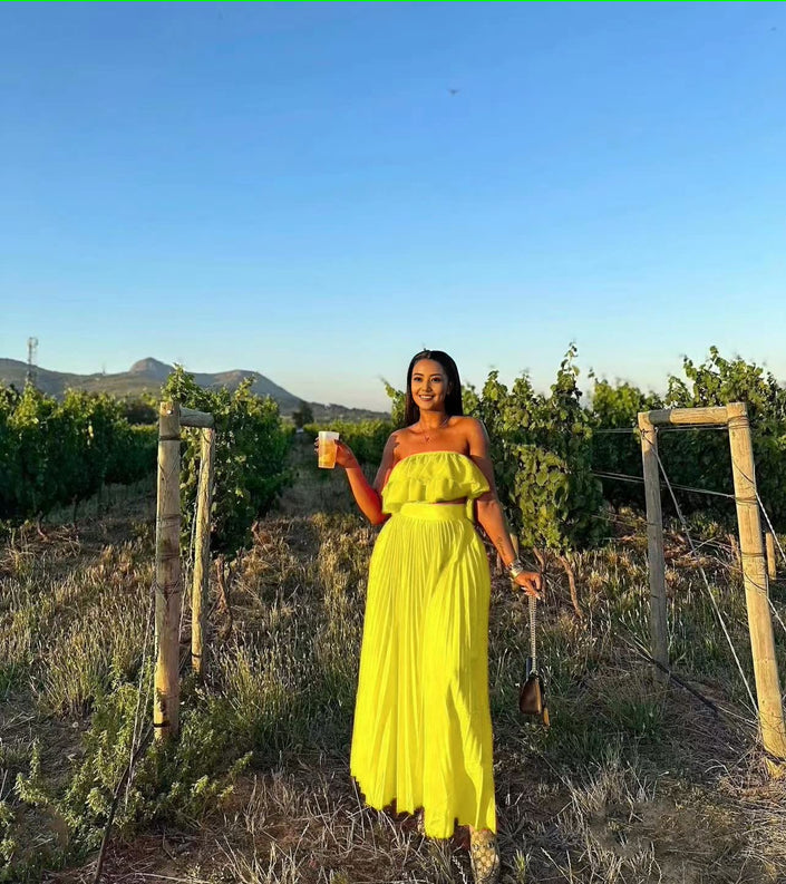 Yellow off-shoulder maxi dress with ruffle neckline and tiered, gathered skirt