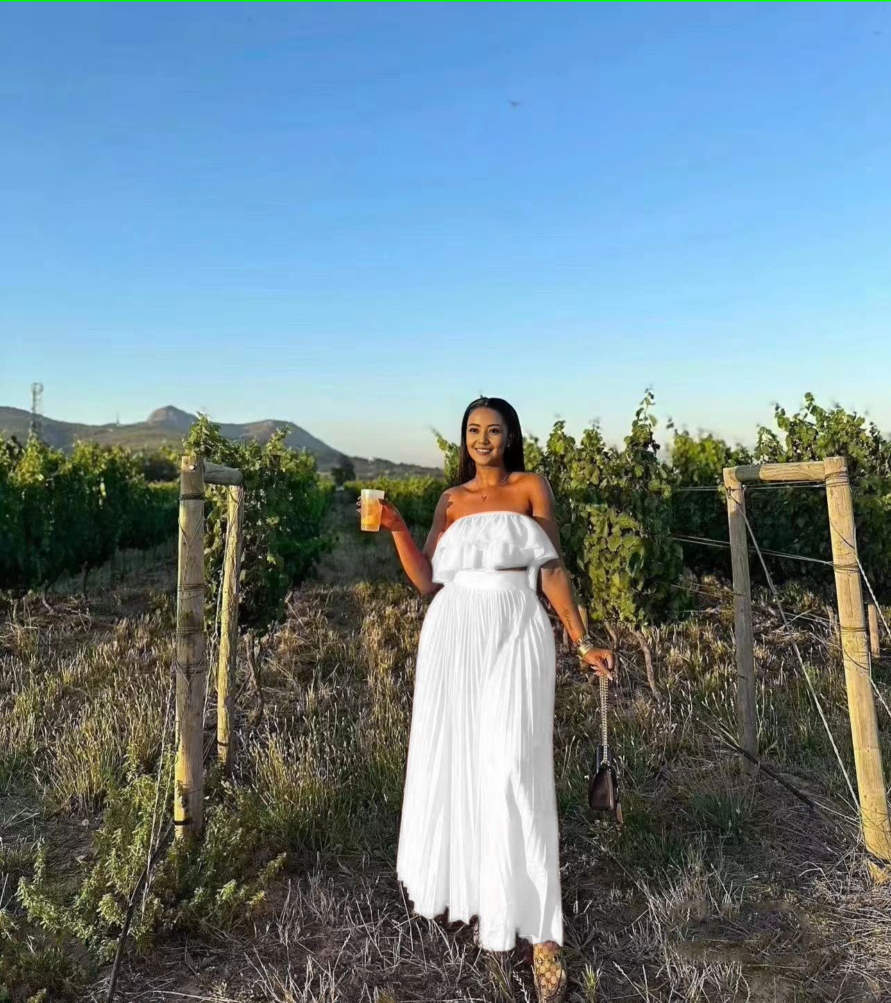 White off-shoulder maxi dress with ruffle neckline and tiered, gathered skirt