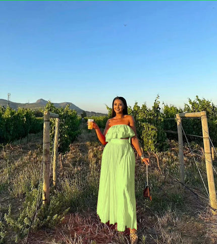 Light-green off-shoulder maxi dress with ruffle neckline and tiered skirt