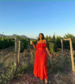 Red off-shoulder maxi dress with ruffle neckline and tiered skirt