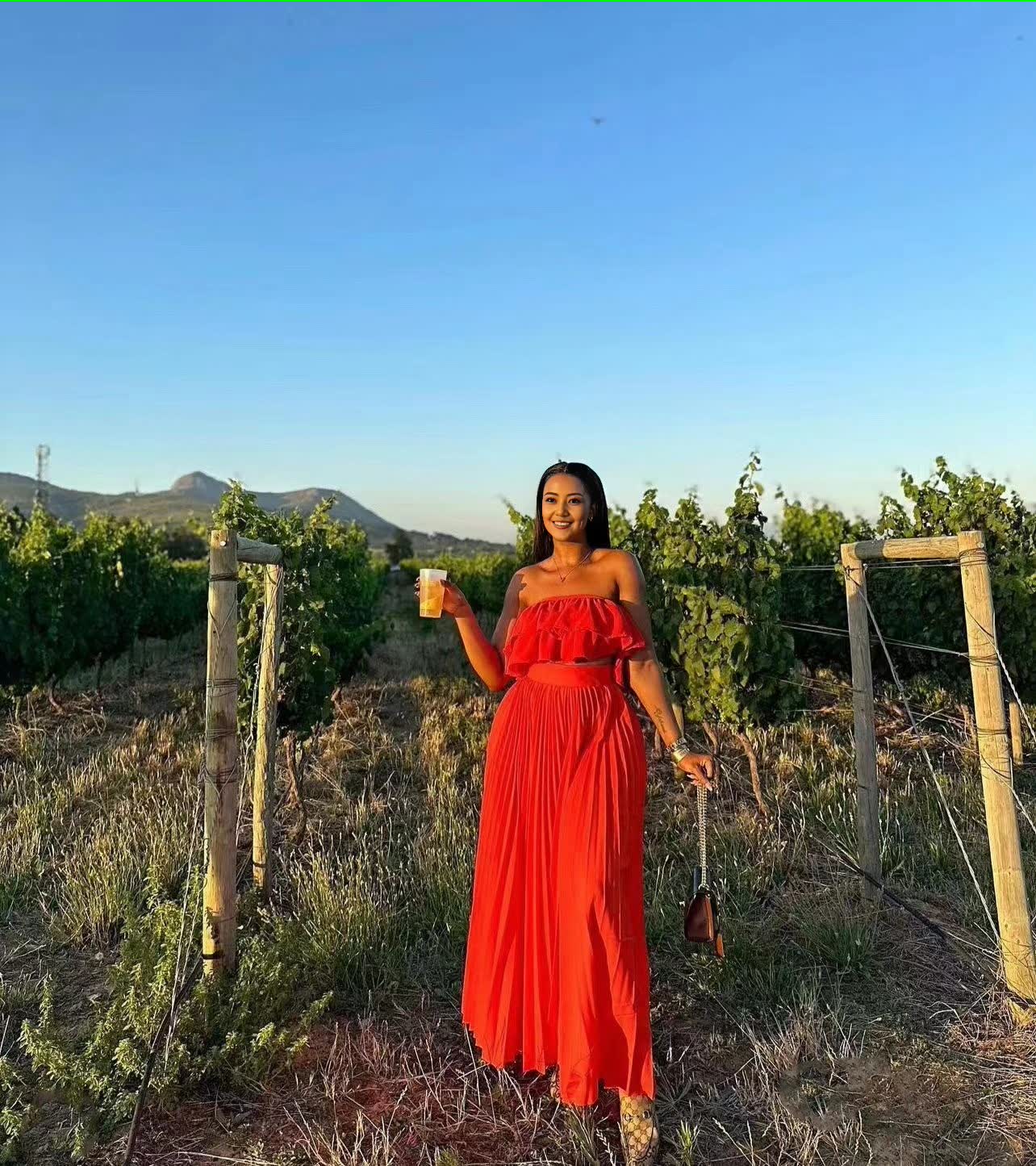 Red off-shoulder maxi dress with ruffle neckline and tiered skirt