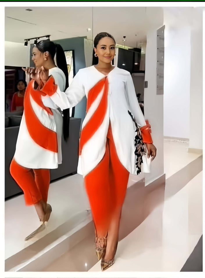 White asym hem top with draped orange panel and fitted orange trousers