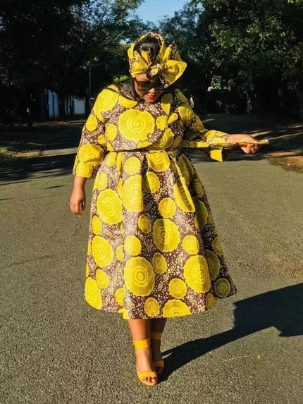Yellow African print midi dress with long sleeves and flared skirt, circular motifs