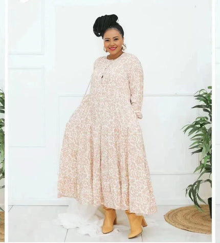 Peach floral maxi dress with long sleeves and tiered skirt