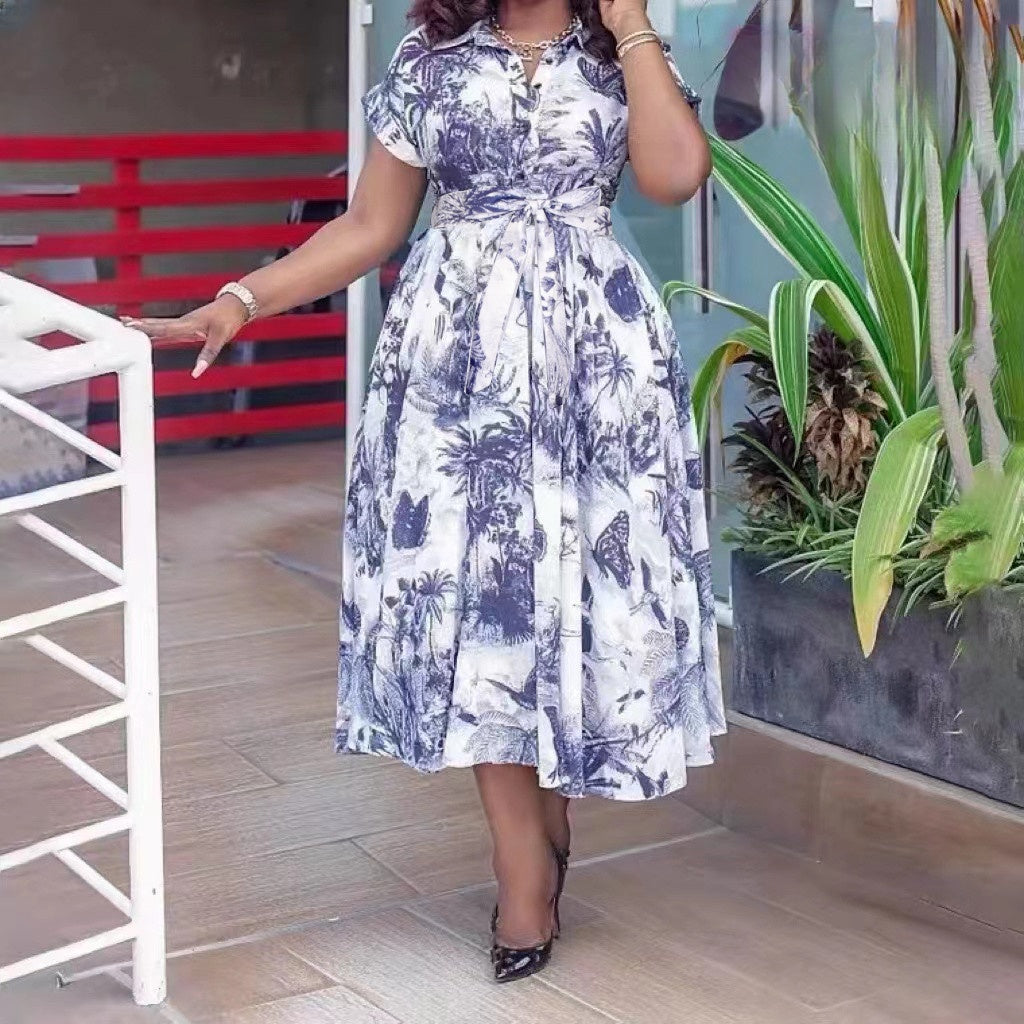 Belted tropical print midi dress, blue and white, short sleeves, flared skirt.