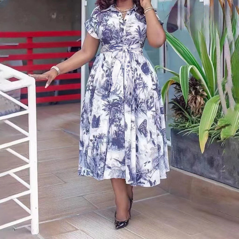 Belted tropical print midi dress, blue and white, short sleeves, flared skirt.