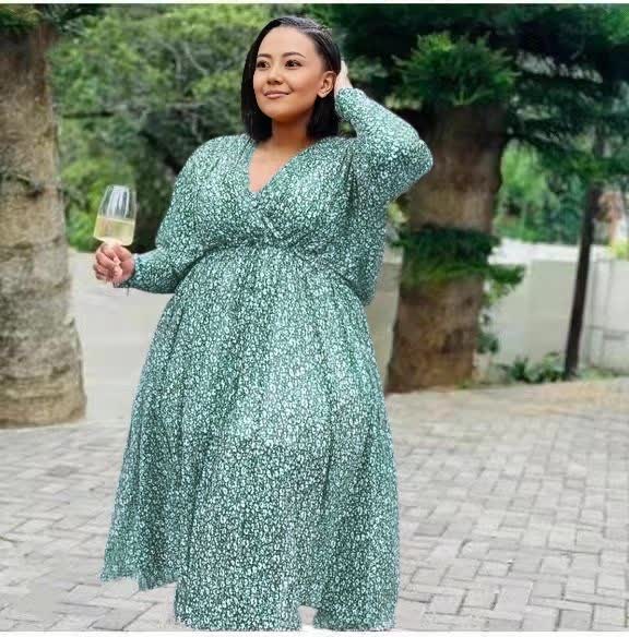 Plus size midi dress in light green with V-neck, cinched waist, long sleeves, patterned fabric