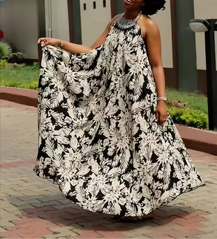 Black and white halter maxi dress with flowing floral print, sleeveless halter neckline