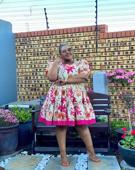 Floral puff-sleeve mini dress with pink-red blooms, gathered waist, white background.