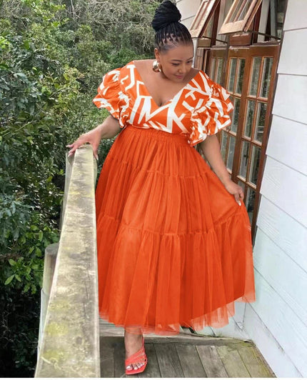 Orange-red tiered tulle maxi dress with puff sleeves and white patterned V-neck trim