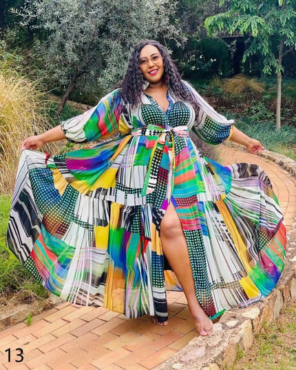 Plus-size maxi dress, pleated skirt with colorful geometric print and tied waist belt.
