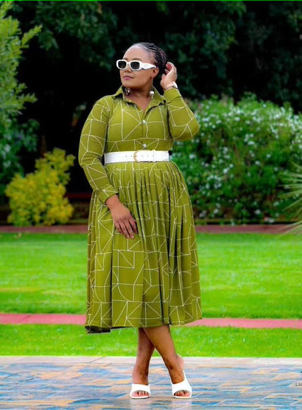 Green geometric midi dress with long sleeves, button front, and white belt