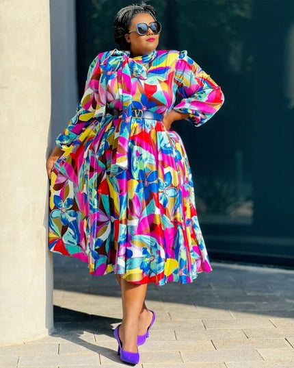 Plus size A-line dress with colorful floral print, puff sleeves, and waist belt
