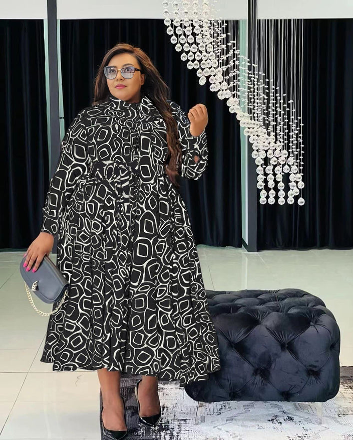 Belted flare midi dress in black with geometric print, long sleeves and high neck