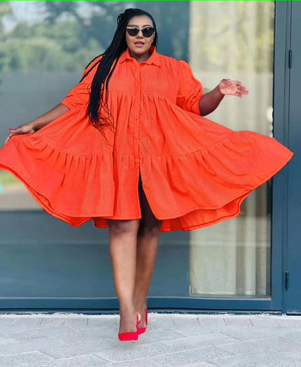 Orange-red ruffle-hem shirt dress with button front and tiered skirt, long sleeves