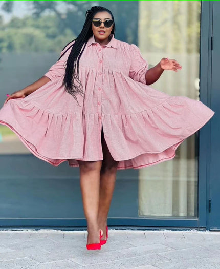 Pale pink ruffle-hem shirt dress with button front and tiered skirt, long sleeves