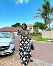 Black-and-white geometric maxi dress with long sleeves and wavy hem
