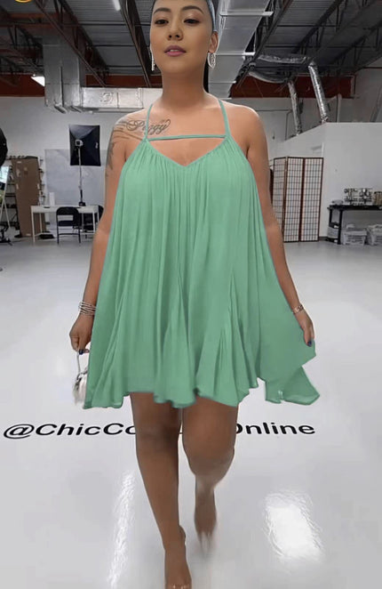 Pale turquoise sleeveless flared dress with spaghetti straps, V-neck bodice, pleated skirt