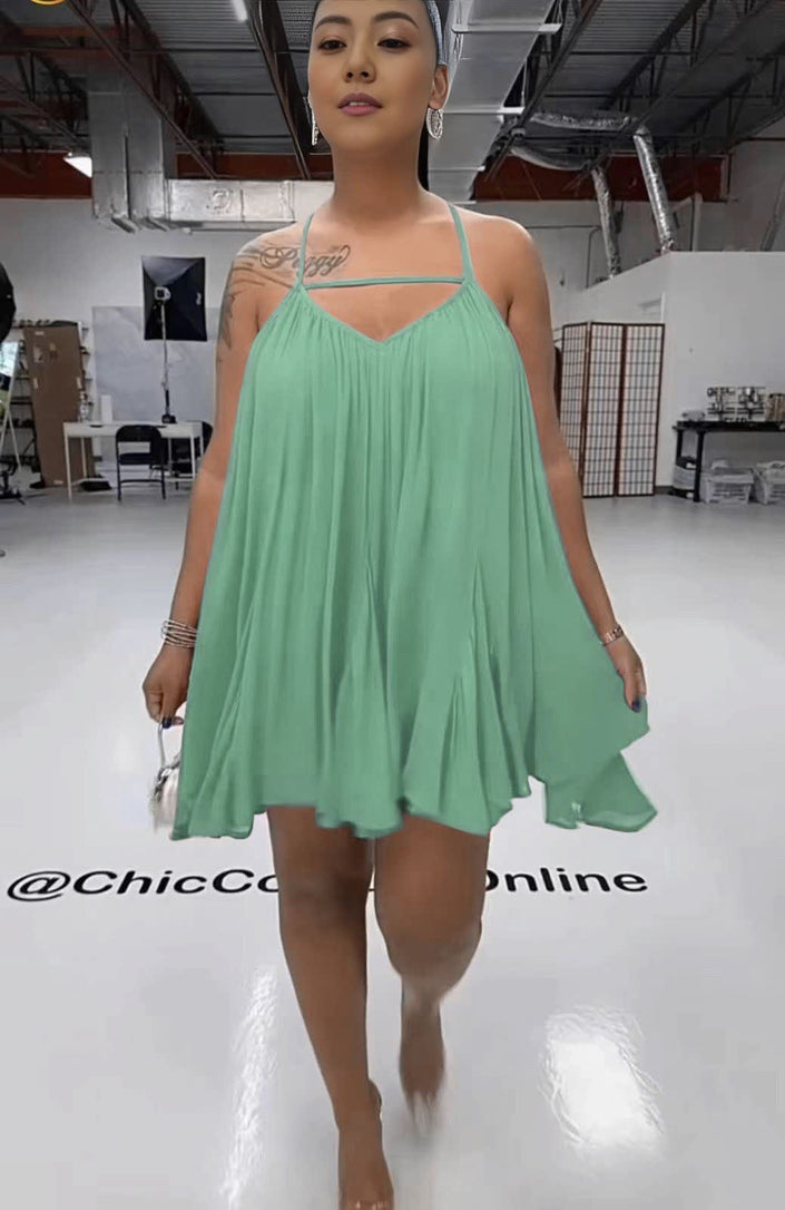 Pale turquoise sleeveless flared dress with spaghetti straps, V-neck bodice, pleated skirt
