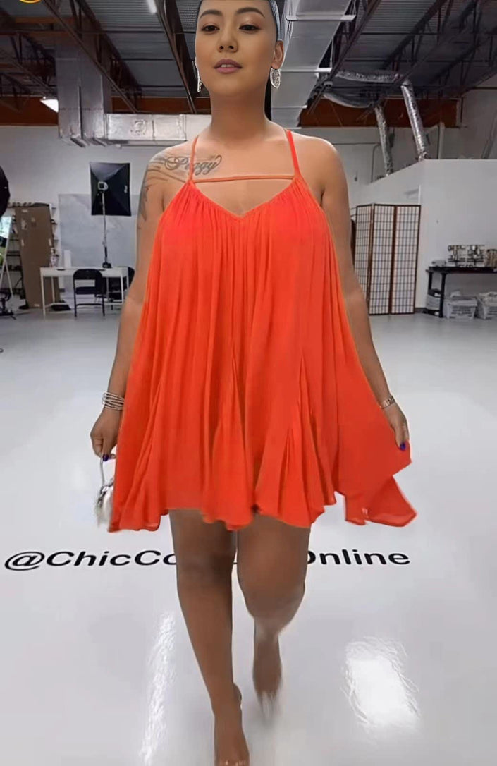 Orange-red sleeveless flared dress with spaghetti straps and V-neck, pleated swing skirt