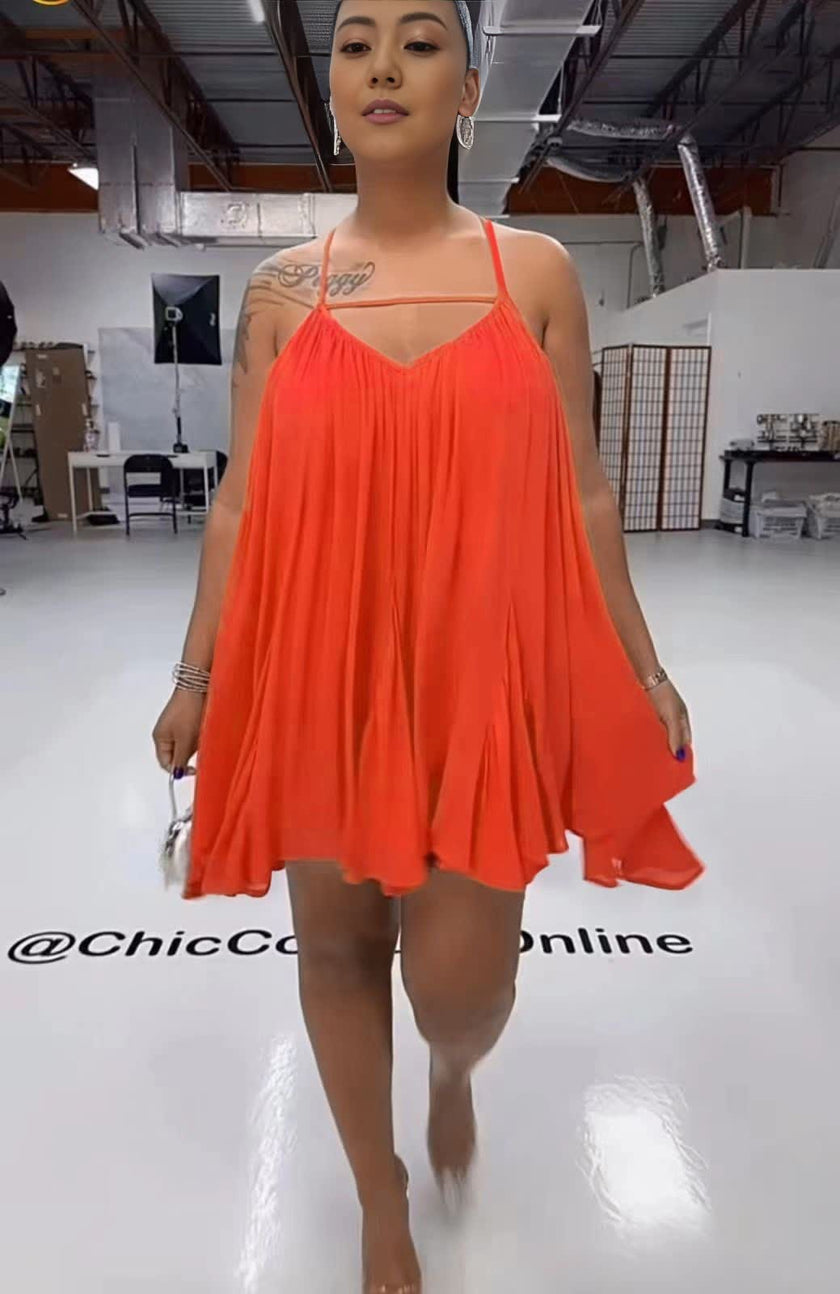 Orange-red sleeveless flared dress with spaghetti straps and V-neck, pleated swing skirt
