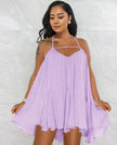 Light purple sleeveless flared dress with spaghetti straps and V-neck, pleated swing skirt