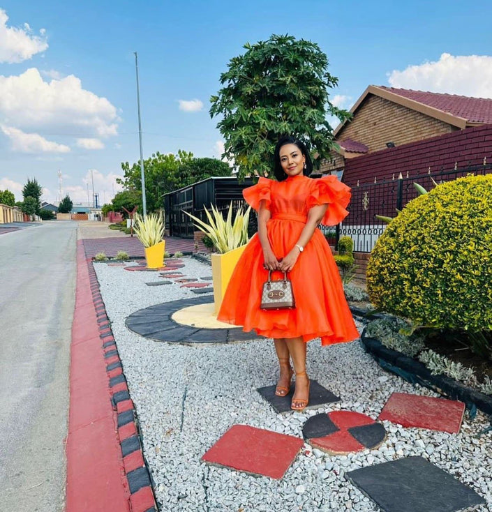Orange-red puff-sleeve midi dress with flared skirt and gathered waist