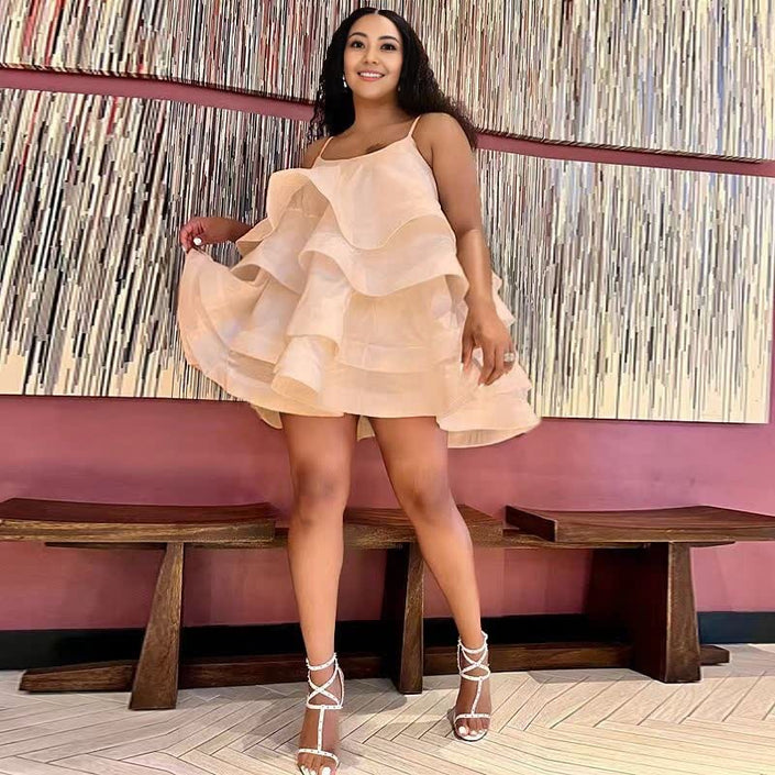 Ivory tiered ruffle mini dress with adjustable spaghetti straps and flared layered hem.