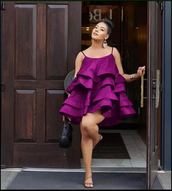Purple tiered ruffle mini dress with adjustable spaghetti straps and layered ruffle skirt.