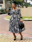 Black-and-white patterned midi dress with puff sleeves, square neckline, gathered skirt.
