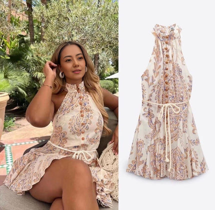 Printed halter mini dress with ruffled neckline, tie waist, and flared tiered skirt