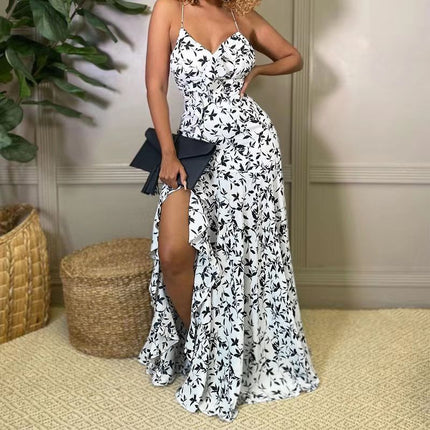 White maxi dress with spaghetti straps, black floral print, and side slit