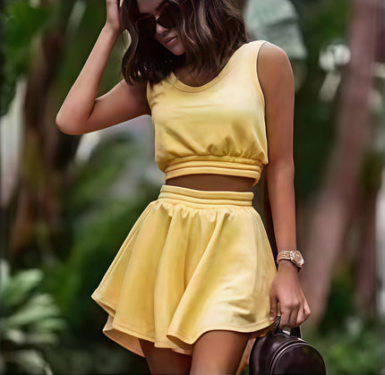 Yellow pleated skirt set with sleeveless cropped top and elastic waistband