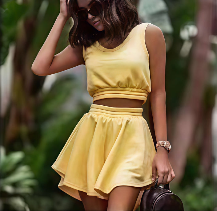 Yellow pleated skirt set with sleeveless cropped top and elastic waistband