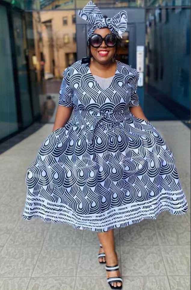 Blue and white swirl-pattern midi dress with flared skirt and bow-tied waist