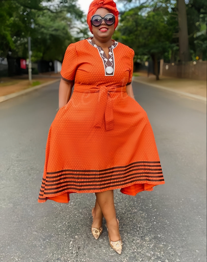 Orange fit-and-flare midi dress with striped hem, short sleeves, and tie waist
