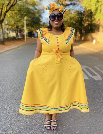 Yellow ruffle sleeve dress with rainbow-trim edges, button front and waist bow