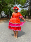 Layered ruffle dress in orange with white trim and pink underskirt, short sleeves