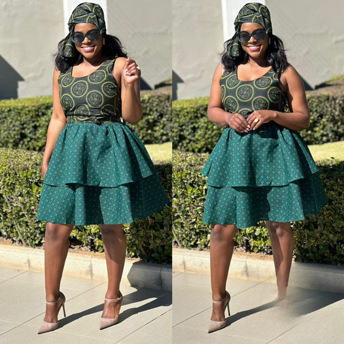 Sleeveless green patterned ruffle skirt dress with layered skirt and matching headwrap