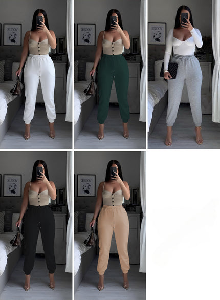 White high-waist jogger pants with stretch waistband and tapered ankle cuffs