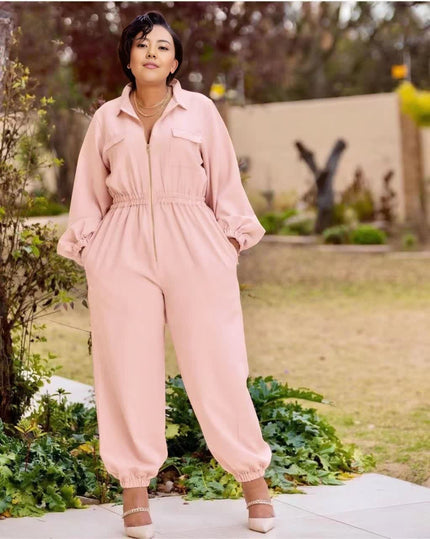 Pink collared zip-front jumpsuit with long sleeves, gathered waist, tapered jogger legs.