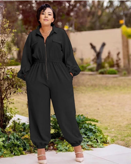 Black collared zip-front jumpsuit with long sleeves, gathered waist, cuffed tapered legs.