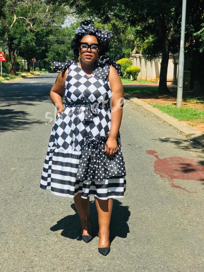 Checkered midi dress with bow waist and polka-dot skirt tiers, sleeveless black-and-white