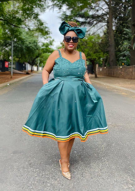 Teal flared dress with rhinestone bodice, sleeveless straps, striped hem