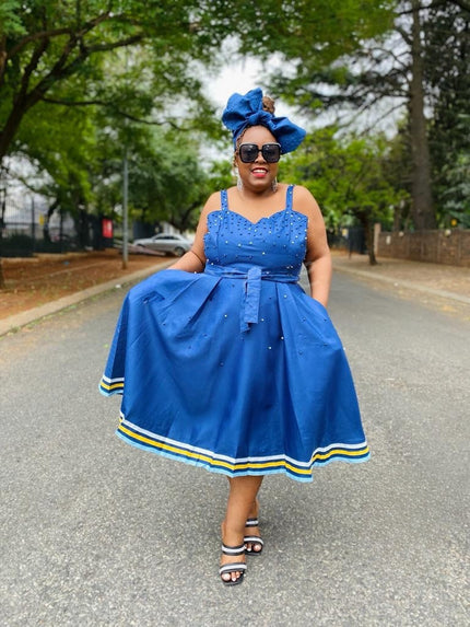 Blue A-line flared dress with rhinestone bodice, sleeveless straps, striped hem