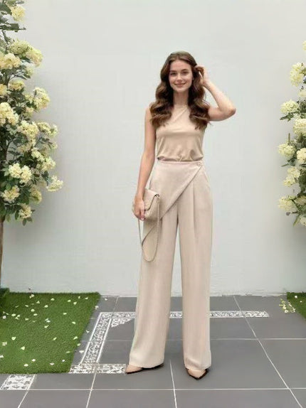 Beige wide-leg pants with asymmetric front flap detail and relaxed straight legs